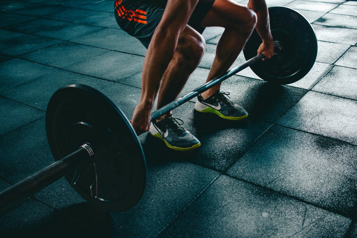 A professional bodybuilder tracking progress in a workout journal